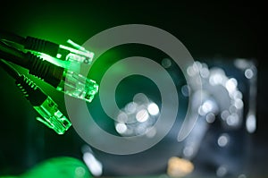 Network switch and ethernet cables, symbol of global communications. Colored network cables on dark background with lights and smo