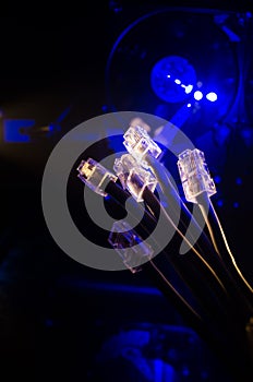 Network switch and ethernet cables, symbol of global communications. Colored network cables on dark background with lights and smo