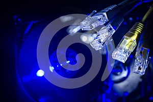 Network switch and ethernet cables, symbol of global communications. Colored network cables on dark background with lights and smo