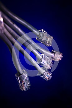 Network switch and ethernet cables, symbol of global communications. Colored network cables on dark background with lights and smo