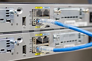 Network switch in rack, network cables connect SFP module port