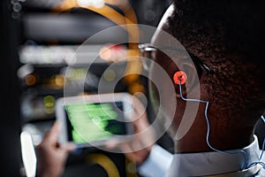 Network technician wearing ear protection while working in server room