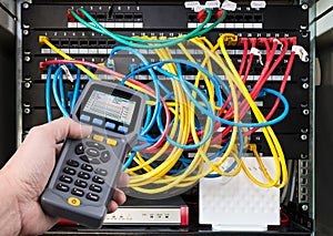 Network test. Qualified cable performance tester in human hand detail