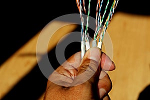 Networking and security concepts. Hand holding a network and telephone cable