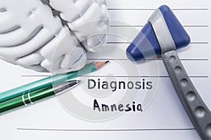 Neurological diagnosis of Amnesia. Neurological reflex hammer, shape of the brain, pen and pencil the lying on a medical report, l