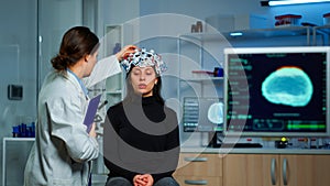 Neurological doctor cheking eeg headset explaining treatment