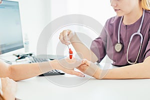 Neurological examination. The neurologist testing hand reflexes on a female patient using a hammer. Diagnostic, healthcare,