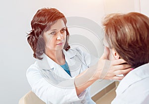 Neurological examination. The neurologist testing reflexes on a female patient