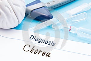 Neurological hammer, brain shape, syringe with needle and vials of medicines are next to inscription Diagnosis Chorea. Diagnostics