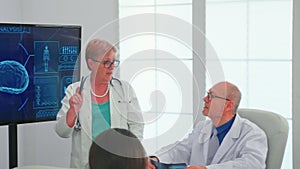 Neurologist reading brain waves on monitor