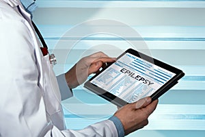 neurologist reading epilepsy disease diagnosis in digital medical report photo