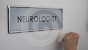 Neurologist room door, hand knocking closeup, nervous system disorder, reflex