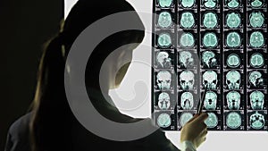 Neurosurgeon analyzing brain x-ray, blood vessels problems, incurable illness