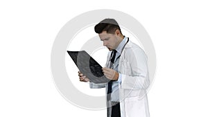 Neurosurgeon observing MRI scan, examining progress of disease on white background.