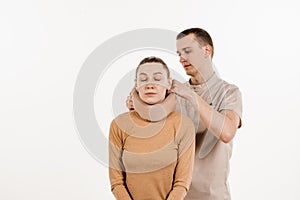 Neurosurgeon puts cervical soft collar or neck brace bandage on young woman to support and immobilize neck or for treat
