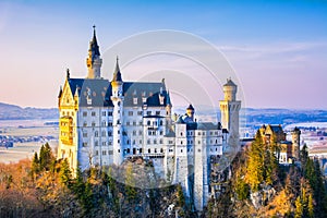 Neuschwanstein, beautiful fairytale castle near Munich in Bavaria, Germany, with colorful trees.