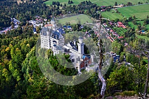 Neuschwanstein castle on Alps background in vicinity of Munich, Bavaria, Germany, Europe. Autumn landscape with castle