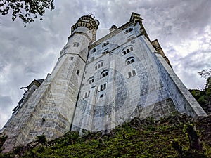 Neuschwanstein Castle covered in fog during a rainy summer day. Closeup.