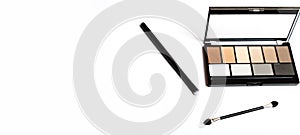 Neutral brown eye shadow palette with brush on white background. Female decorative cosmetics. Copy space