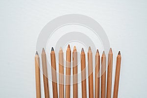 Neutral color skin pencils disperse on a white canvas