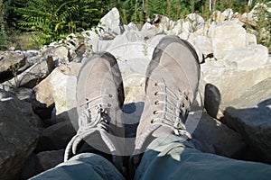 Neutral grey barefoot running shoes . Foot view with white stoned background . Natural grey sandy stone colors matching with shoes