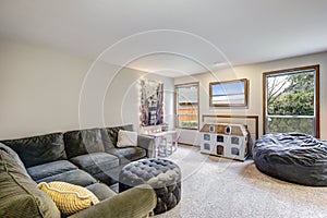 Neutral living room interior with grey corner sofa
