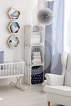 Neutral nursery with cradle and chair
