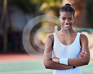 Never give up, never give in. an attractive young woman standing alone on a tennis court.