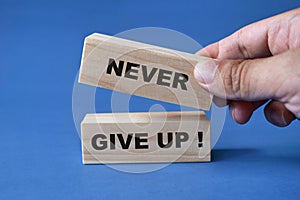 Never give up, text words typography written on wooden blocks, business life and self development