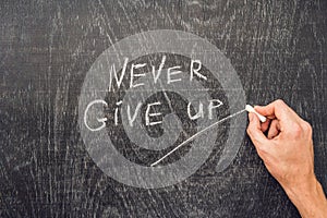 Never give up words written on the chalkboard