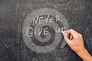 Never give up words written on the chalkboard