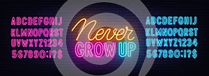 Never grow up neon sign on brick wall background.