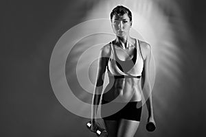 She never quits. Monochrome studio portrait of a fitness female posing