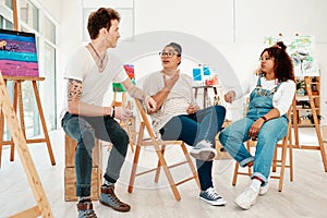 We never run out of things to say. a diverse group of friends sitting together and talking during an art class in the