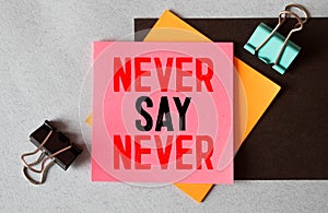 NEVER SAY NEVER lettering on pink sticker