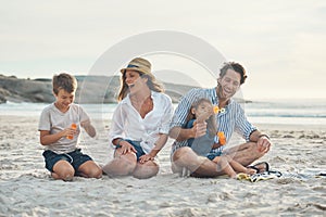 We never stop laughing around our children. Full length shot of a happy couple sitting with their two children who are