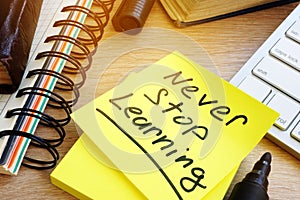 Never stop learning written on a stick. Lifelong learning concept. photo