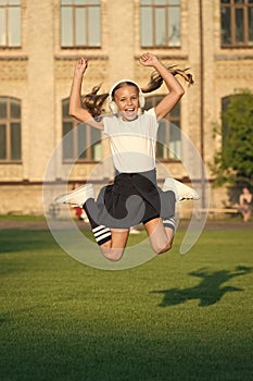 Never stop. Stereo headphones. Girl listening music modern gadget. Schoolgirl with wireless headset dancing jumping