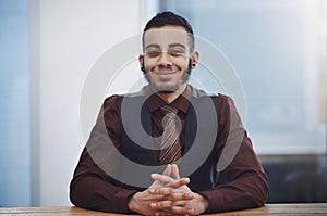 Never stop truly believing in yourself. Portrait of a young businessman sitting in an office.