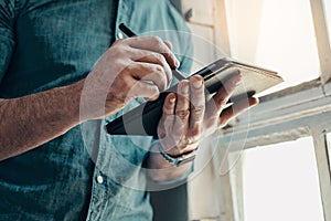 Never undermine the creativity of your hands. an unrecognizable businessman using a digital tablet while standing in a