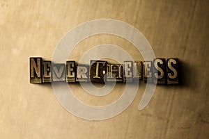 NEVERTHELESS - close-up of grungy vintage typeset word on metal backdrop