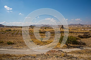 NEVSEHIR DISTRICT, CAPPADOCIA, TURKEY: Beautiful autumn landscape on fields, rocks and mountains. On the horizon the silhouette of