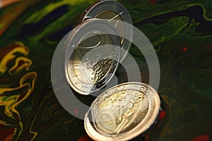 New 2 euro coins stand on the edge. Close-up.