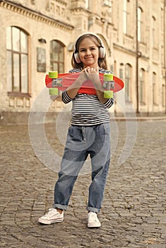 New adventure awaits. Happy kid hold penny board outdoors. Aboveground transportation. Adventure travel. Childhood