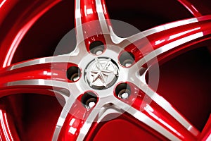 new alloy car wheel closeup, red color