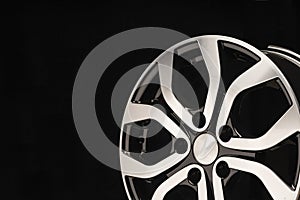 New alloy wheel of the car, close-up on a black background, wheel spokes. beautiful design. copy space