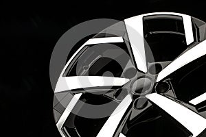 New alloy wheels on a black background. stylish and beautiful. auto parts and auto tuning