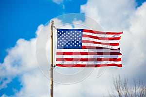 New American flag on an old pole blowing in the wind