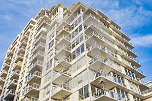 New apartment building on a sunny day with a blue sky. Facade of a modern multistoried new stylish living block of flats