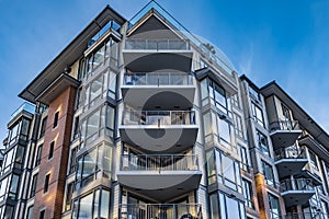 New apartment building on a sunny day with a blue sky. Facade of a modern multistoried new stylish living block of flats